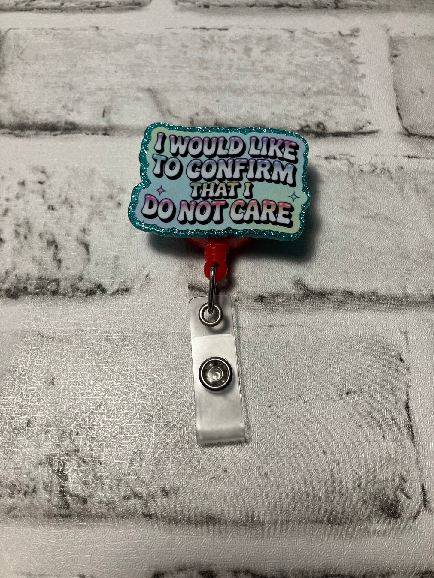 I would like to confirm I don’t care pink badge reels