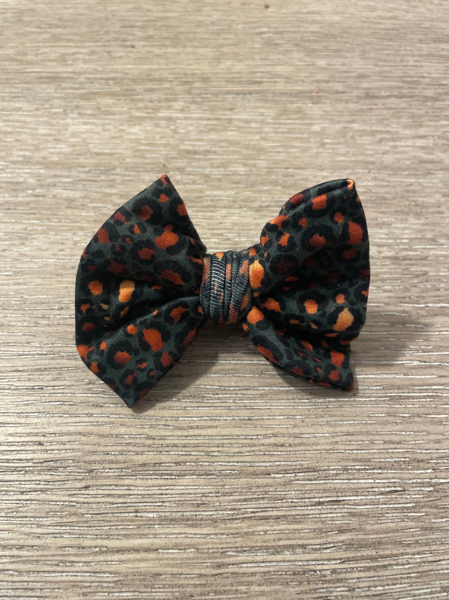 Deep teal gold leopard clip bow