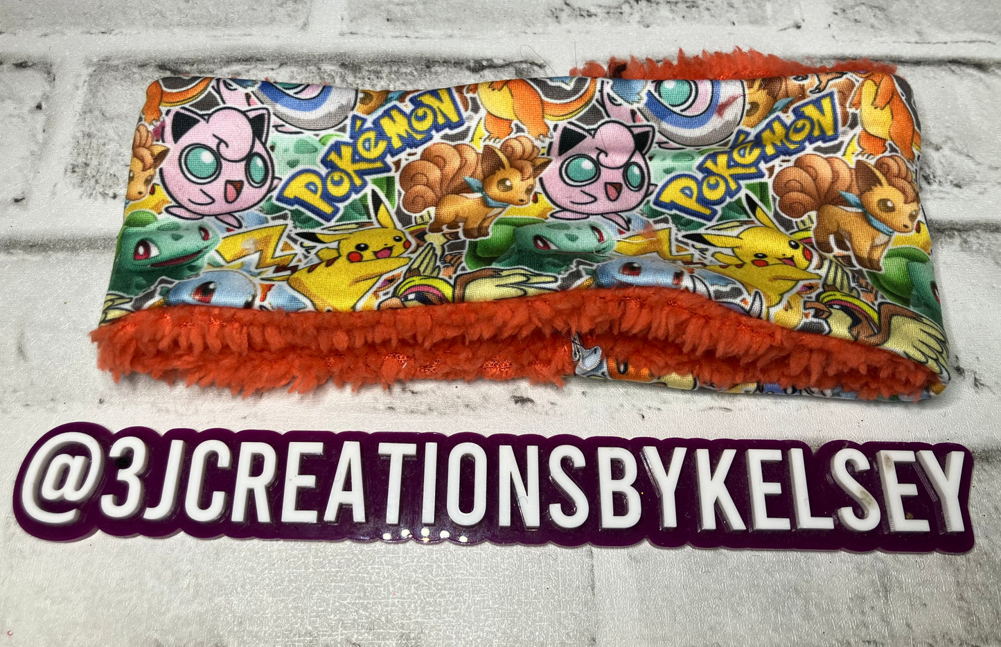 Gotta catch them all orange child ear warmer🪩