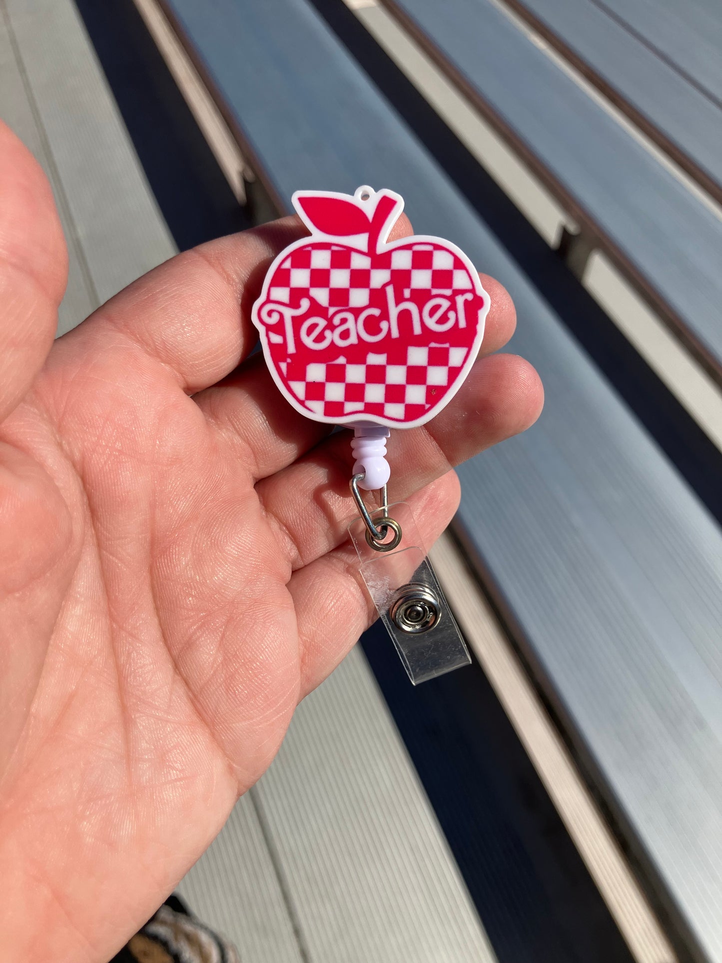 Pink teacher Apple badge reels