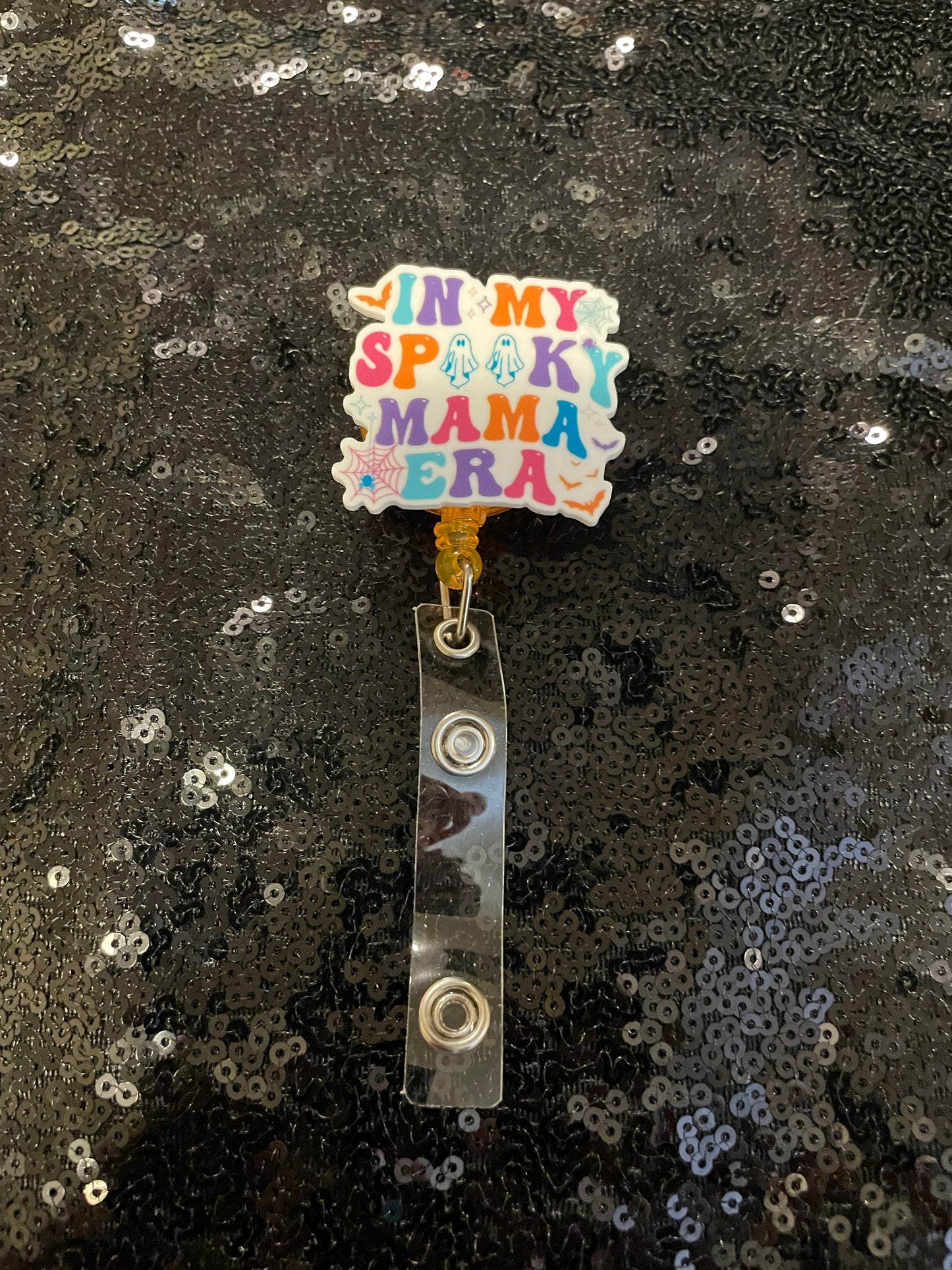 In my spooky mama era orange badge reel💚