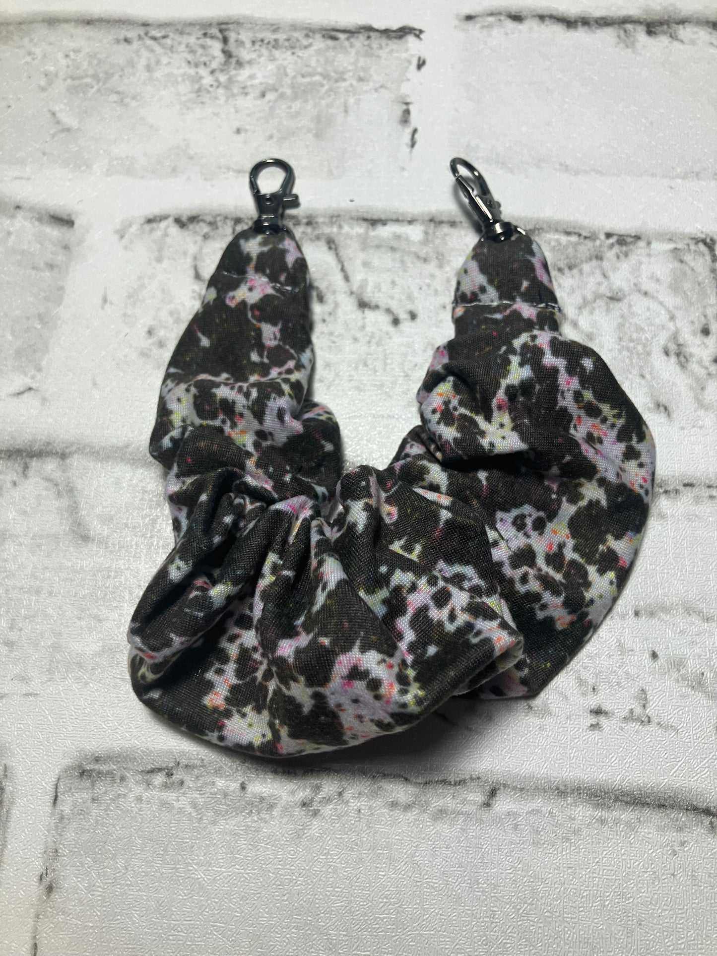 Paint splatter cow scrunchie phone holder