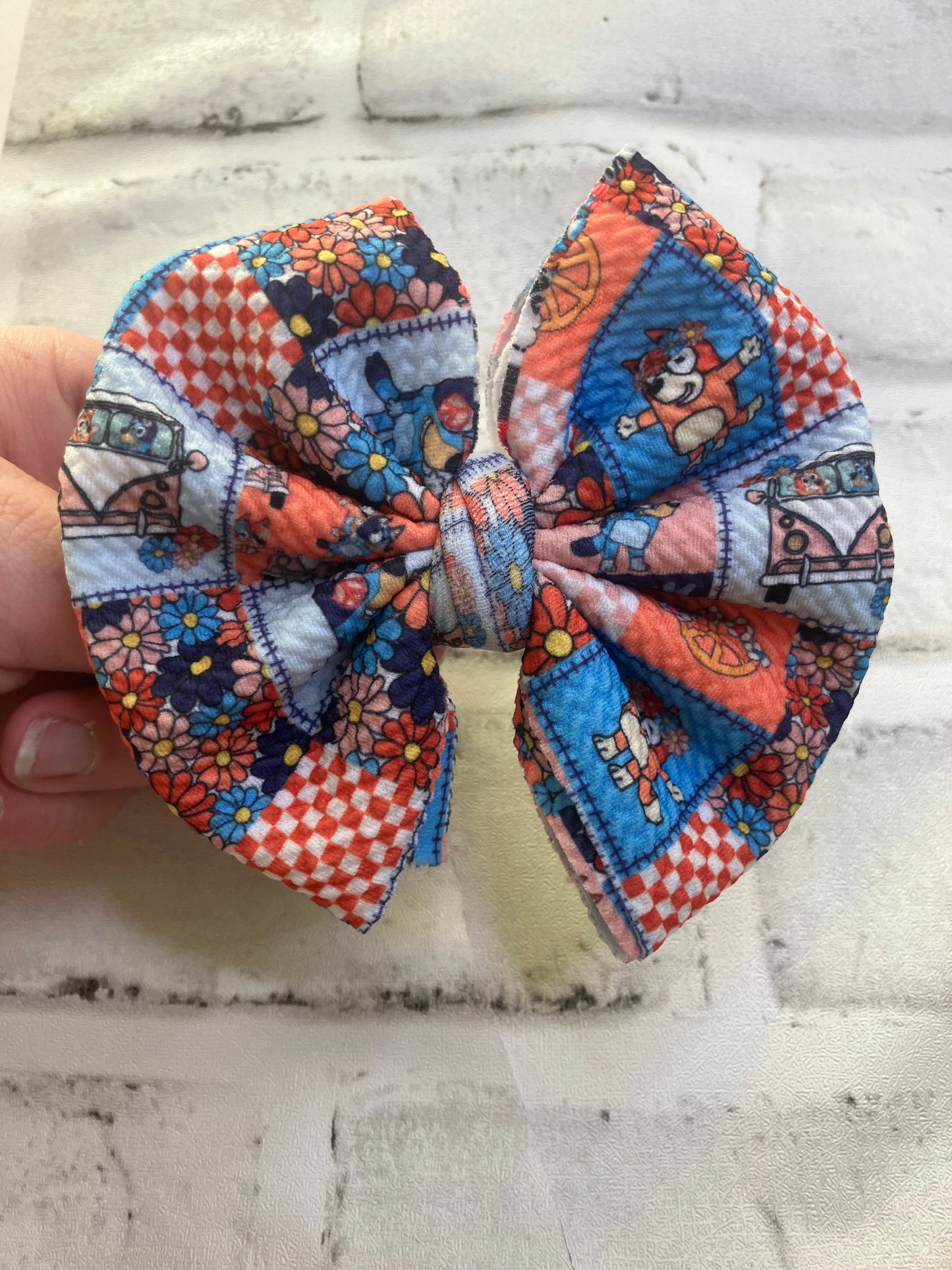 Blue dog and orange dog clip bow