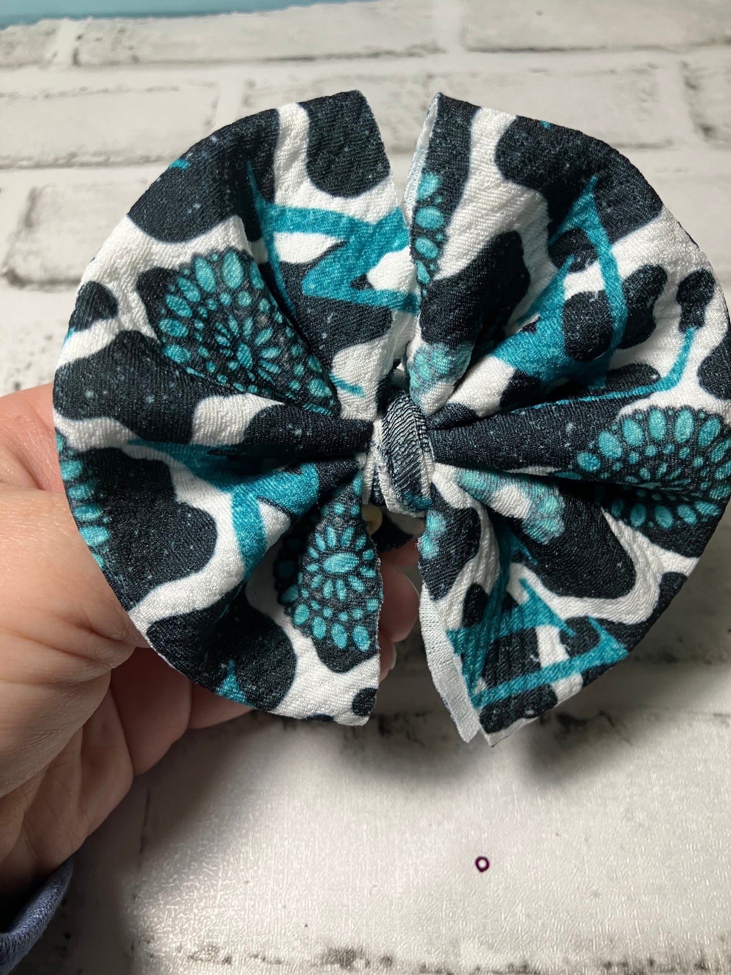 High end teal cow clip bow