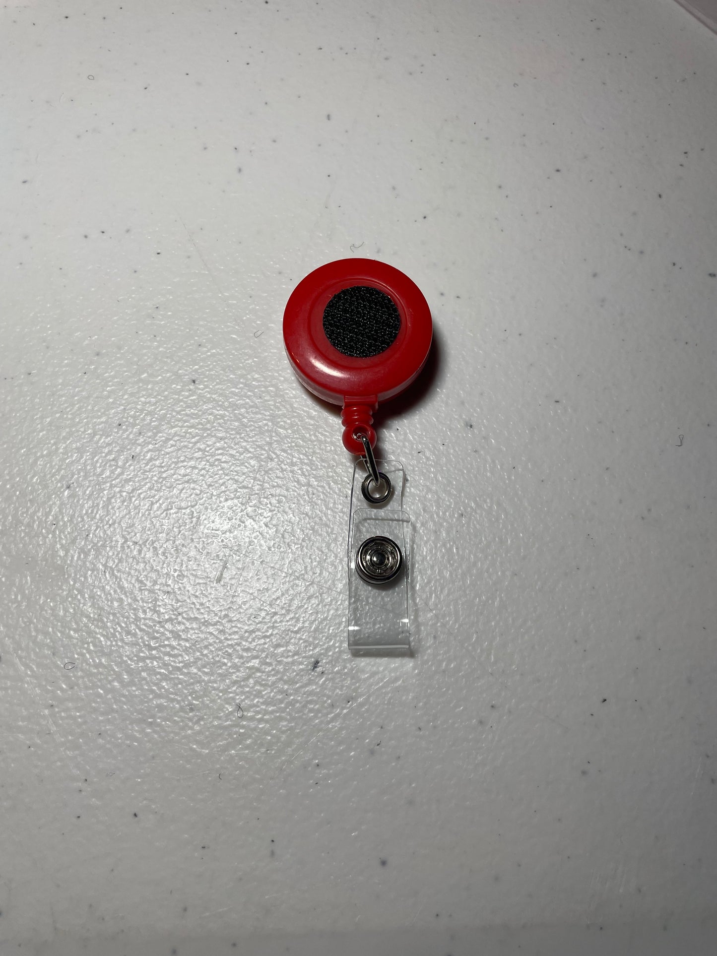 Solid red badge reel base