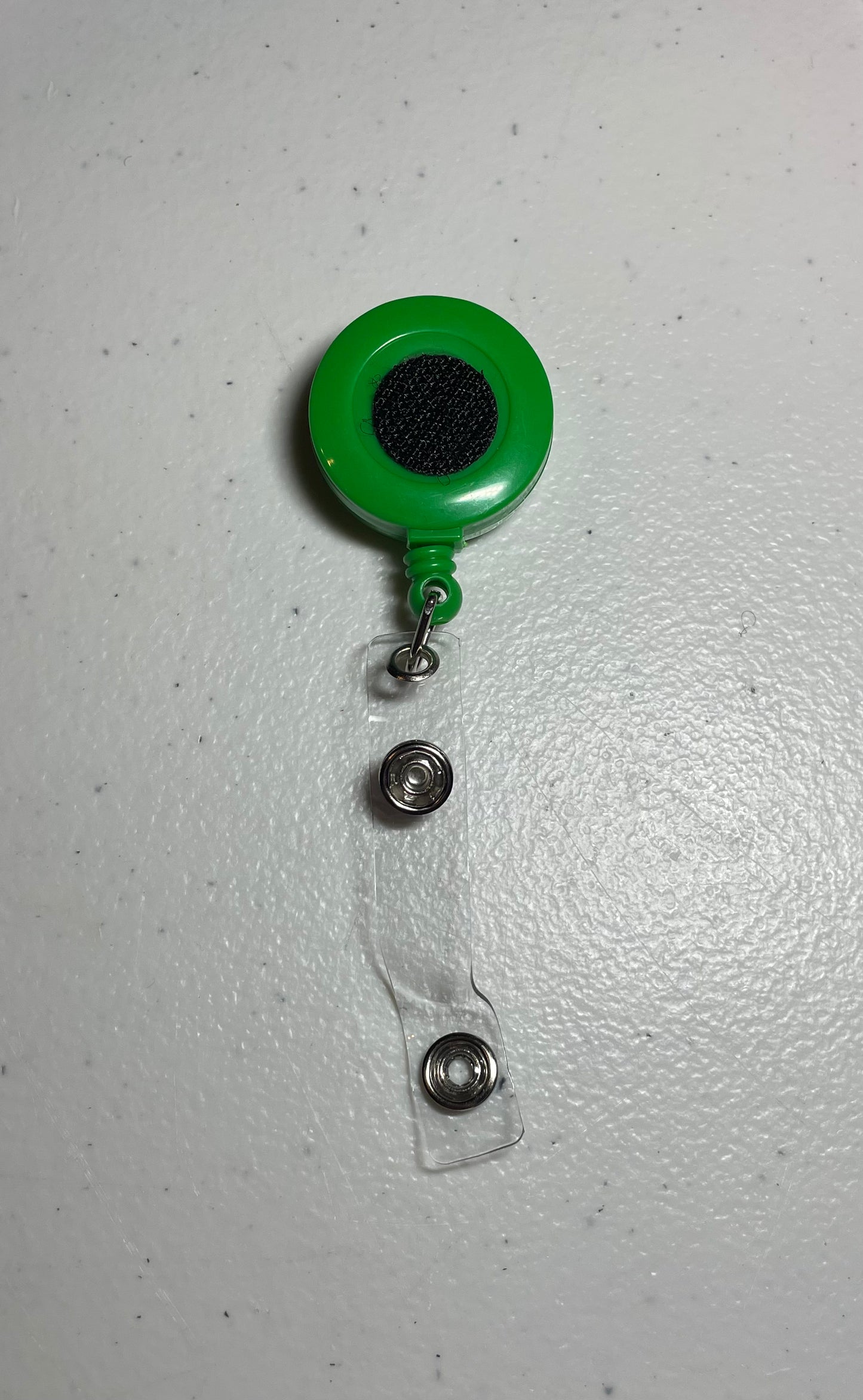 Solid green badge reel base