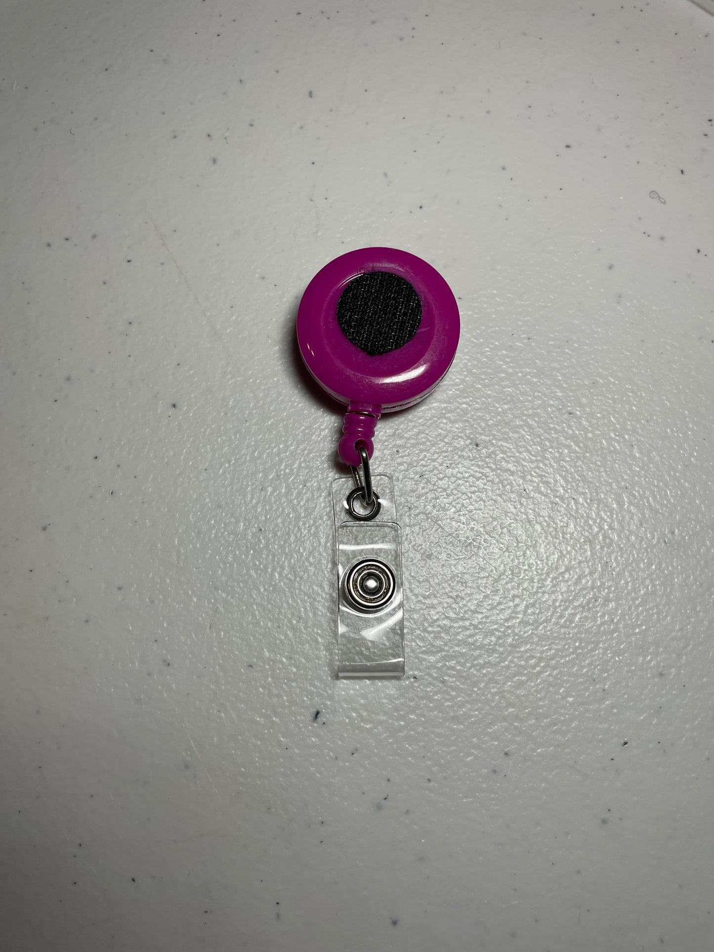 Solid magenta badge reel base